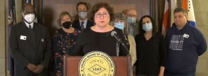 (Legislator MaryJane Shimsky at podium, behind her L to R: Stacy Osborne, President, GROW Inc.;Board Vice Chair Nancy Barr; Michael Orth, Commissioner, Dept. of Community Mental Health; Shari Ascher, Director of Policy & Programs for Small Business and Chambers of Commerce; Evan Latainer, Director, Westchester County Office for People with Disabilities; Carin Horowitz, Chair, Westchester County Advisory Council on People with Disabilities;Michael Gilberg, member, Advisory Council on People with Disabilities)