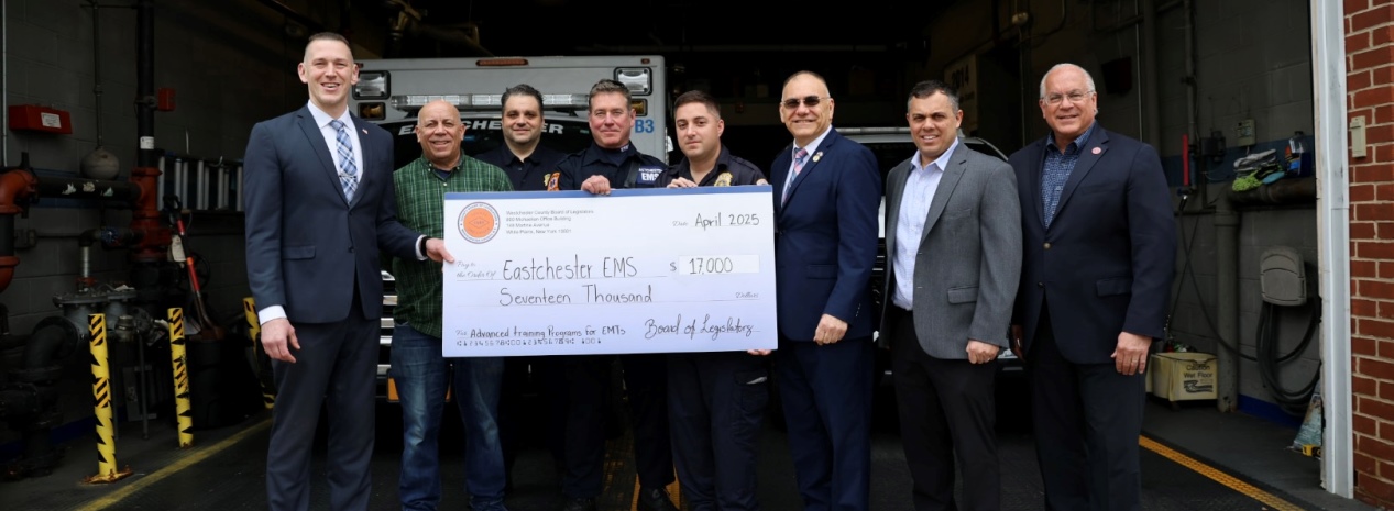 Legislators Judah Holstein and James Nolan present a check to Eastchester's Volunteer Ambulance Corps