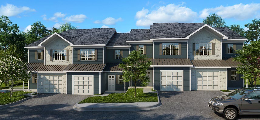 A modern townhouse complex featuring multiple units with attached garages, light gray and blue siding, and a neatly landscaped front yard, set against a backdrop of trees and a clear blue sky.